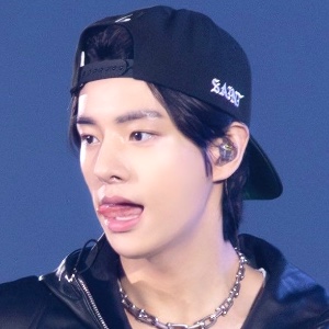 black hair in backwards cap