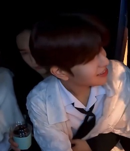 hyunjin’s holding coffee in one hand and seungmin in the other
