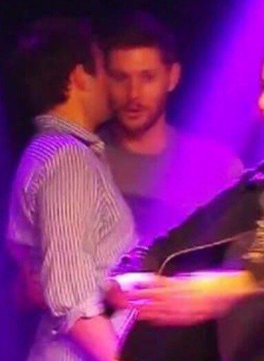 Jensen holding Misha's waist while whispering